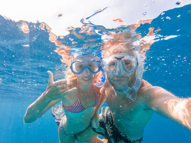 istock Young couple take selfie underwater with snorkelling mask 1364624204
