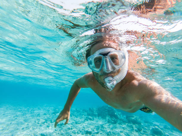 istock Young man takes selfie underwater with snorkelling mask 1364624846
