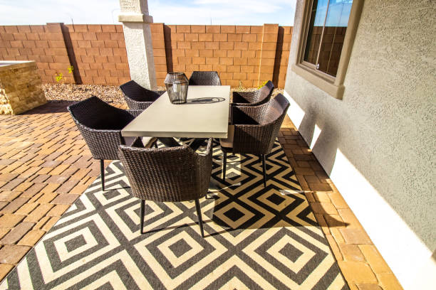 Outdoor Patio Area With Table And Six Wicker Chairs