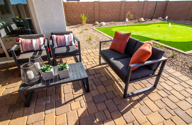 Rear Patio Furniture Including Table, Chairs And Couch Rear Patio Of Table, Chairs And Couch On Brick Pavers putting green stock pictures, royalty-free photos & images