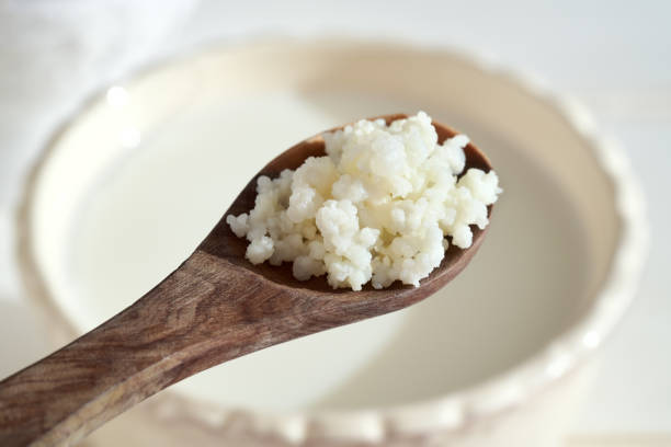 istock Kephir grains on a spoon above a cup of milk 1364627551