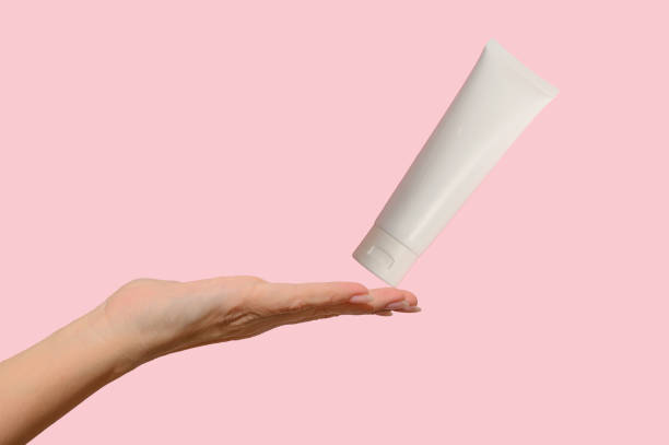 istock Hand holds a white container with cosmetic cream. For body care. 1364628634