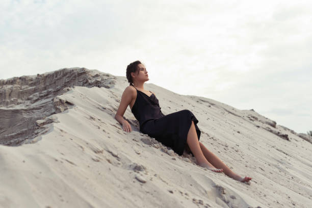 istock Tanned brunette in the sand dunes 1364628652