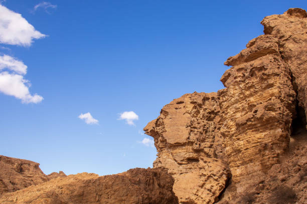 istock rocks in form of a head, with clouds 1364629559