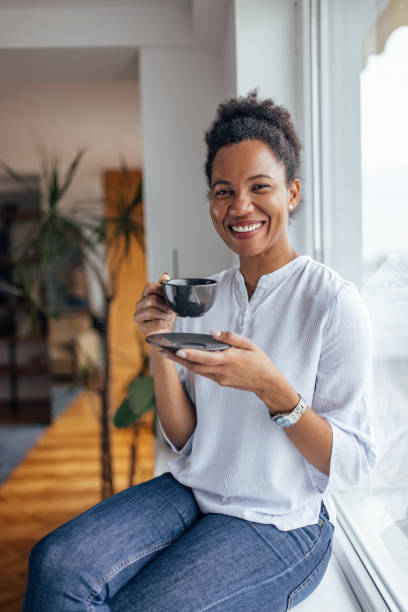 istock Black woman, enjoying at home, alone, drinking hot drink. 1364631411