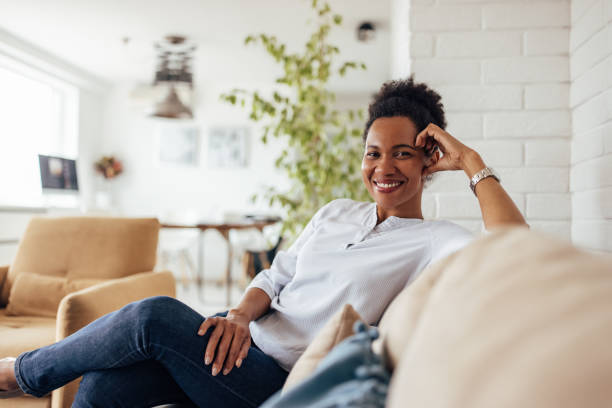 istock African woman, enjoying at home, alone, posing for camera. 1364631419