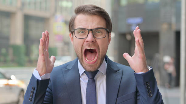 istock Outdoor Attractive Young Businessman Screaming, Shouting 1364631449