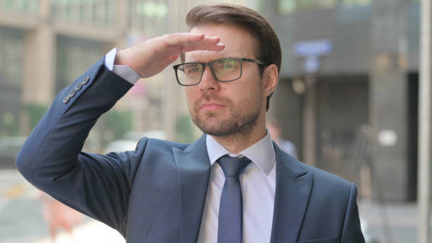istock Outdoor Young Businessman Looking Around, Searching 1364631667