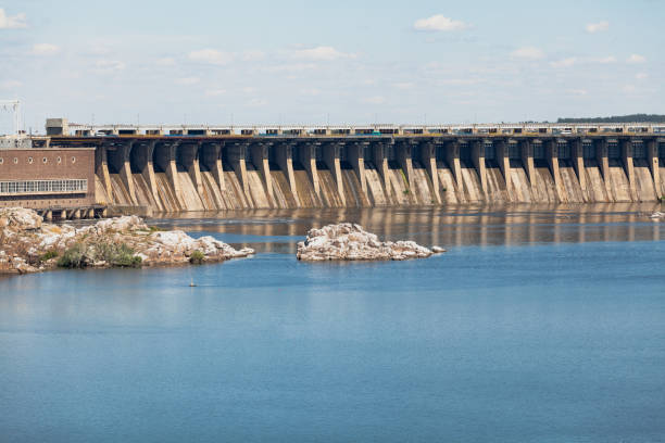 istock Industrial landscape. Powerful concrete dam blocks river 1364632523