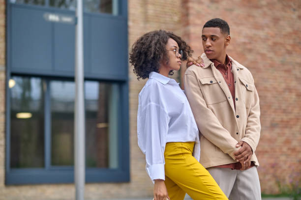 istock Woman sideways to camera touching shoulder of indecisive man 1364634643