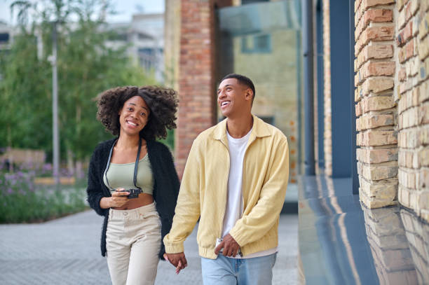 istock Woman looking at camera walking with man 1364634700