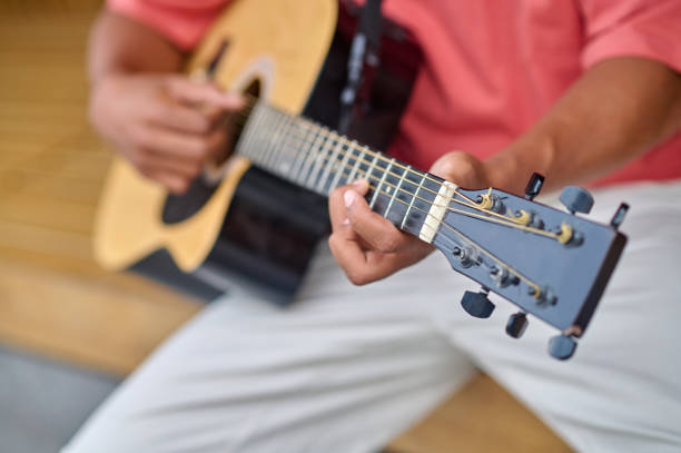 Acoustic guitar player. Classical guitarist playing guitar. Music instrument closeup with hands
