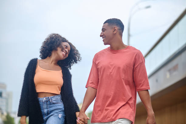 istock Man and woman looking at each other walking 1364634800