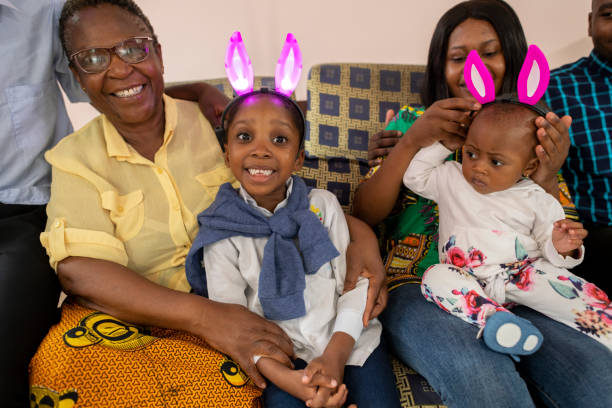 Candid portrait grandchildren wearing Easter bunny ears with grandma