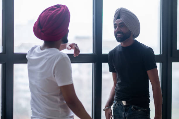 istock Two men in turbans talking and looking involved 1364636171