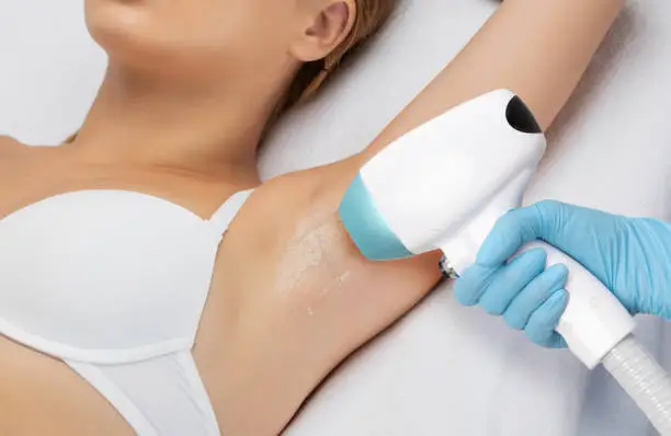 Elos epilation hair removal procedure on a woman"u2019s body. Beautician doing laser rejuvenation in a beauty salon. Removing unwanted body hair. Hardware ipl cosmetology