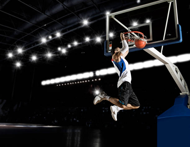 Basketball player in action Basketball player in action in gym slam dunk stock pictures, royalty-free photos & images