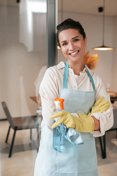 istock Smiling housewife in apron standing in the kitchen 1364638539