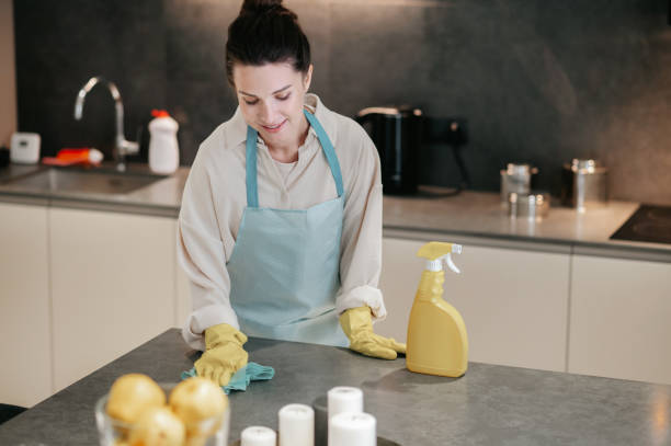 istock Young dark-haired woman looking busy while doing housework 1364638622