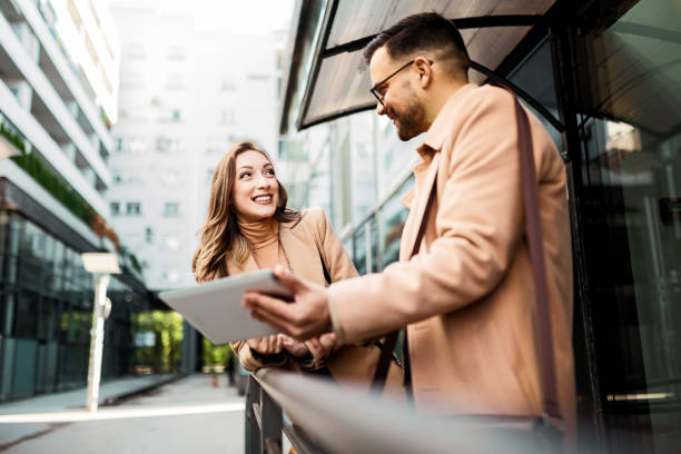 istock Smiling Business people having conversation looking at digital tablet 1364638671