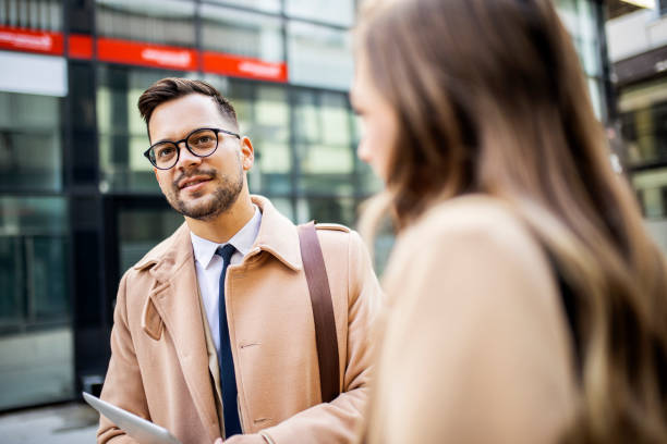 istock Business people talking in front of office 1364638705