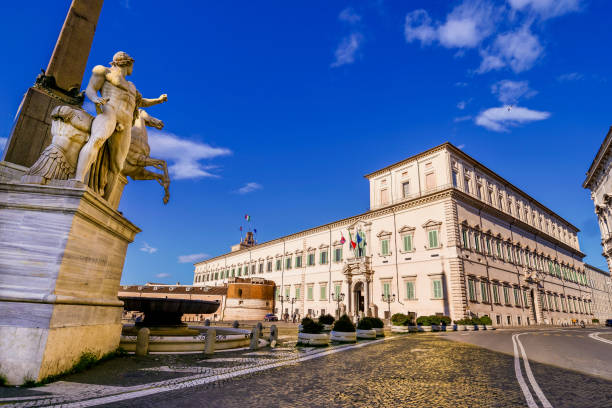 The Presidential Palace of the Quirinale in the heart of Rome with the Fontana dei Dioscuri in the foreground A beautiful wide view of the Piazza del Quirinale (Quirinal Square) with the facade of the Palazzo del Quirinale (Quirinal Palace), in the historic heart of Rome. On the left, in the center of the square, the Fountain of the Dioscuri, Castor and Pollux, coming from the Baths of Constantine, dating back to the Imperial Roman era. The Quirinal Palace is currently the official seat of the President of the Italian Republic, elected every seven years by the Parliament. Built in neoclassical style on the Quirinal hill between 1573 and 1583 as the summer residence of Pope Gregory XIII, this palace over the centuries has been the residence of the Popes (1605-1870), the residence of the King of Italy (1871-1946) and official seat of the Presidency of the Republic (from 1946 to today). Some of the most important Italian architects and artists participated in its construction and decoration, including Gian Lorenzo Bernini, Carlo Maderno, Guido Reni and Domenico Fontana. The Quirinale, with an extension of 110 thousand square meters, is the sixth largest building in the world. In 1980 the historic center of Rome was declared a World Heritage Site by Unesco. Super wide angle image in High Definition format. quirinal palace stock pictures, royalty-free photos & images