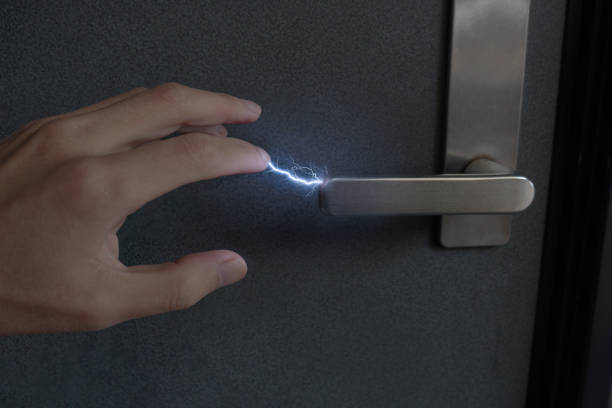 Image of static electricity discharge when touching a lever-type doorknob stock photo