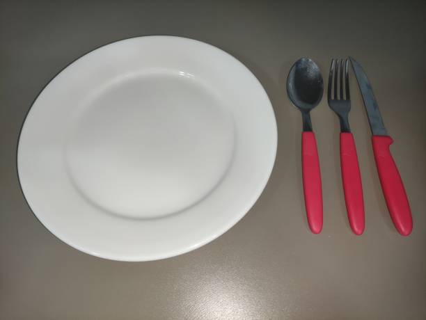 istock red cutlery on white plate low angle 2 1364639852