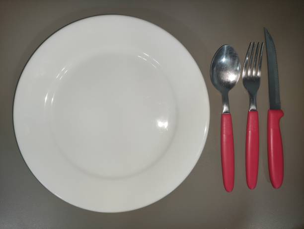 istock red cutlery on white plate top angle 9 1364640681