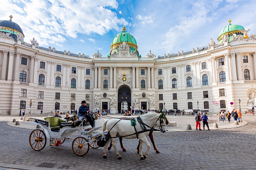 Vienna, Austria - October 2021: Horse carriage at Hofburg palace on St. Michael square (Michaelerplatz)