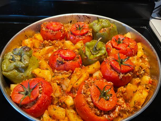 istock Pan of stuffed peppers and stuffed tomatoes with potatoes 1364642470