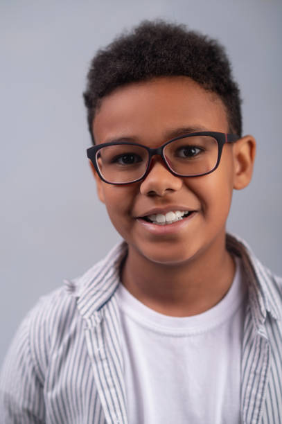 istock Smiling happy kid in spectacles looking ahead 1364643356