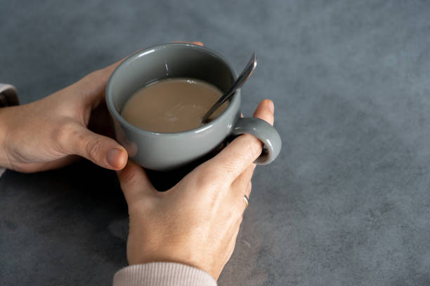 istock girl's hands with coffee cup 1364644755