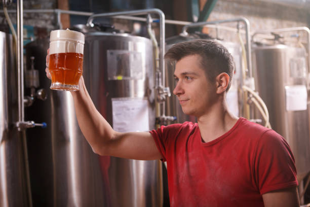 istock Young male brewer working at craft beer production 1364648166