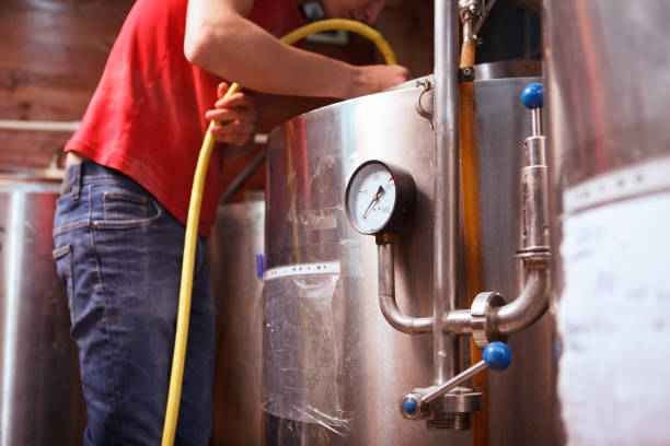 istock Young male brewer working at craft beer production 1364649214