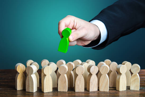 Businessman appoints a leader for the group. Distribution of management in the company. Leading positions, specialized training of managers. Structuring company employees, assigning responsibilities. Businessman appoints a leader for the group. Distribution of management in the company. Leading positions, specialized training of managers. Structuring company employees, assigning responsibilities. positioning stock pictures, royalty-free photos & images