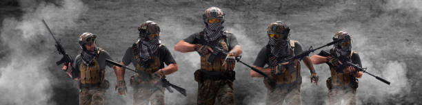 istock Fivel mercenaries soldiers, during a special operation in smoke. Collage - one model in five poses 1364650456