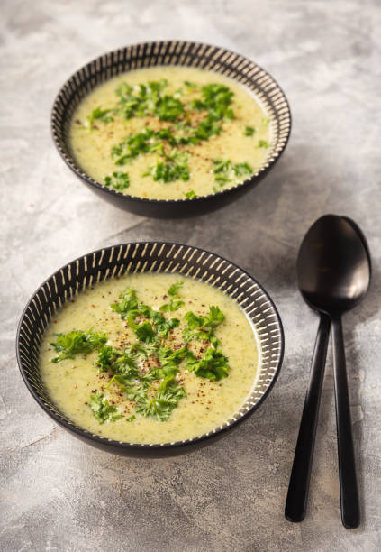 Homemade broccoli cream soup on light background. stock photo