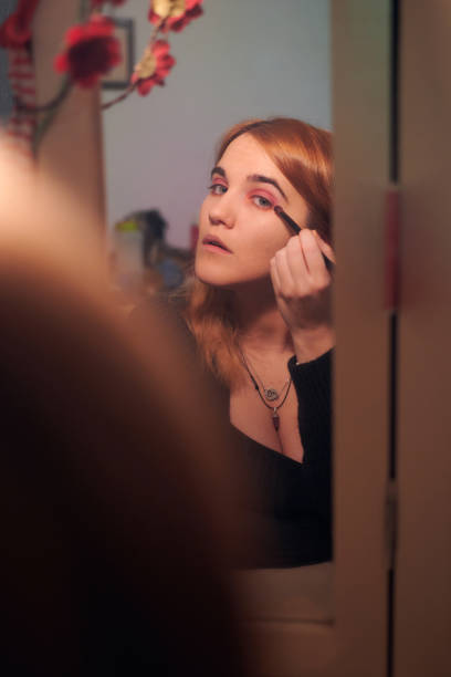 istock Young woman uses makeup for eyelashes 1364651397