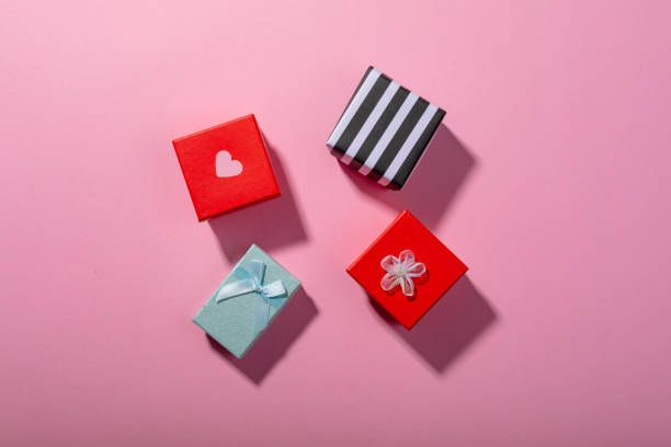 istock Overhead view of colorful gift boxes on pink background, copy space 1364651592