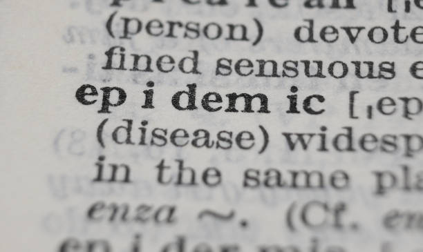 istock Epidemic dictionary definition close-up. Shallow depth of field. 1364653750