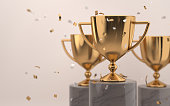 Golden trophy award with falling confetti on grey background. copy space for text. Competition winner prize. 3d rendering.