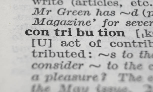 istock Contribution dictionary definition close-up. Shallow depth of field. 1364653818