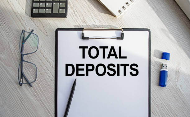 istock Notepad with the inscription TOTAL DEPOSITS. Conceptual image, business accessories, calculator isolated on the desktop. Finance or business concept. 1364654204
