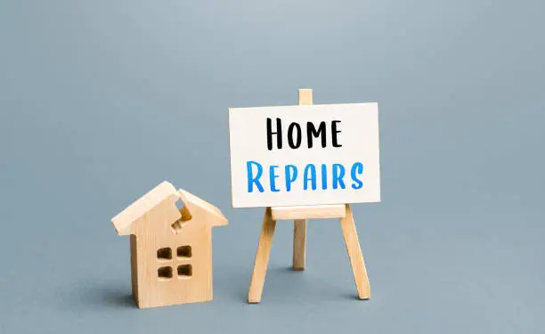 Photo of Cracked house and home repair sign. Restoration of the structure and elimination of damage. Renovation of old building. Property insurance. Reconstruction, repair of the facade.