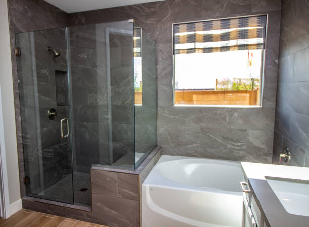 Modern Bathroom With Bath Tub And Glass Shower Modern Bathroom With Vanity, Bath Tub And See-Through Glass Shower enclosure stock pictures, royalty-free photos & images