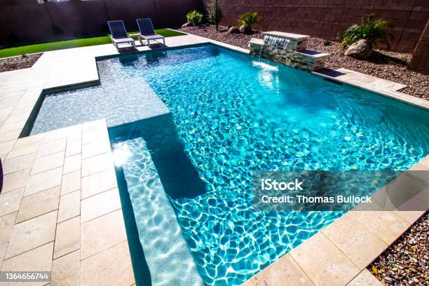 Back Yard With Two Lounge Chairs And Swimming Pool Stock Photo - Download Image Now - Swimming Pool, Back Yard, Tile