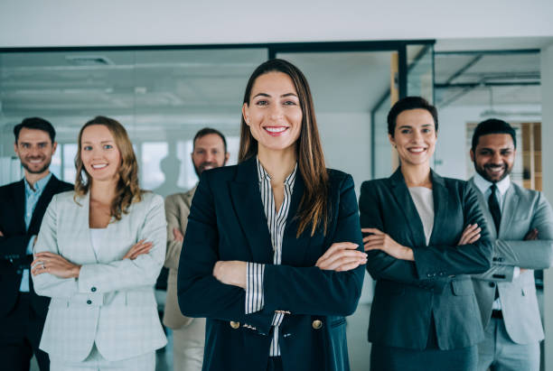 istock Confident businesswoman and her team. 1364656970