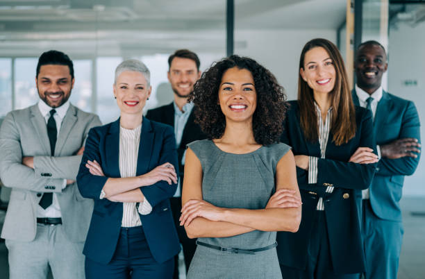 istock Confident businesswoman and her team. 1364656979