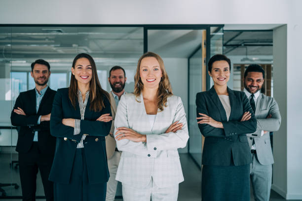 istock Confident businesswoman and her team. 1364657568